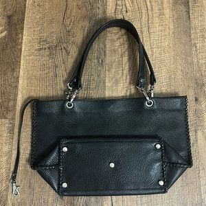 Black boho shoulder bag simple with side details and clip straps stamped “!SKIN”